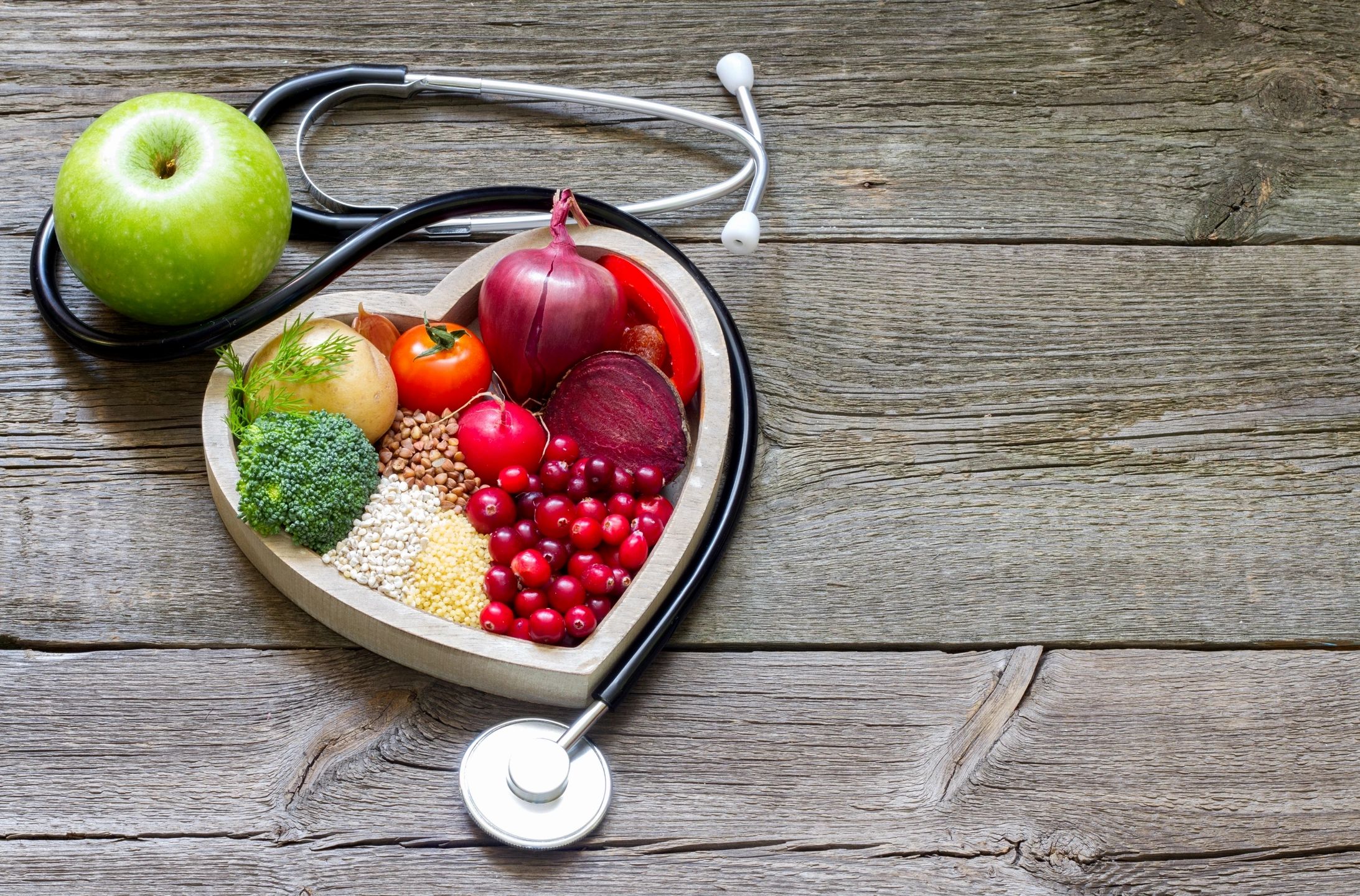 Heart-shaped plate with healthy foods and stethoscope — Chronic Disease Management